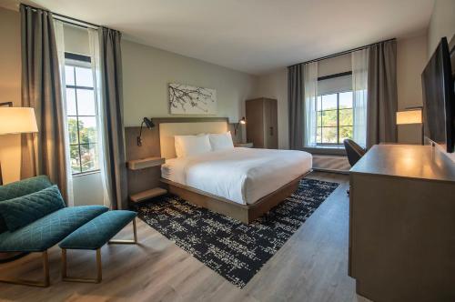 a hotel room with a bed and a desk and chairs at Hotel Rose in Rockford