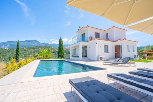 a villa with a swimming pool in front of a house at Villa Sadova Private pool Panoramic view in Kalamata