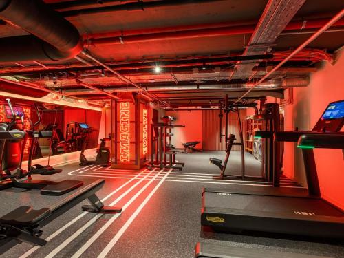 a room with a gym with red walls at You Hotel Budapest - Handwritten Collection in Budapest