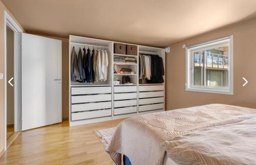 a bedroom with a bed and a closet at Leilighet i Kristiansand in Kristiansand
