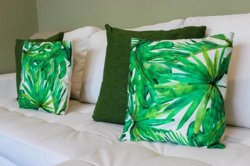 two pillows on a white couch with green pillows at Canavial Terrace@Heart of Funchal in Funchal