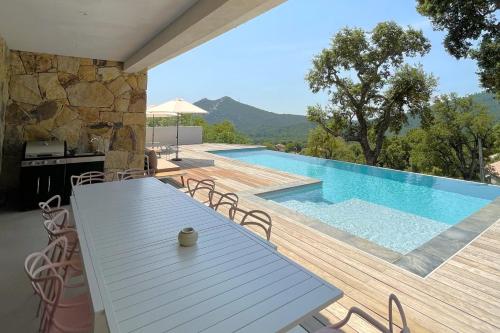 a patio with a table and a swimming pool at Villa Concarella Di Conca in Conca