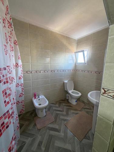 a bathroom with a toilet and a sink at Samadis Home 2 in Larache
