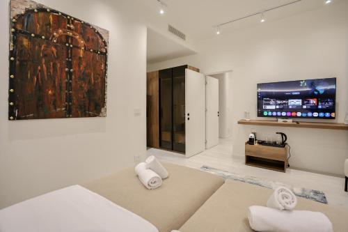 a living room with a couch and a tv at A Gallery Hotel in Shkodër