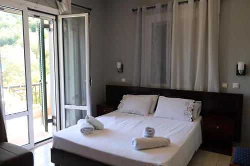 a bedroom with a large bed with towels on it at Ellis Studios in Meganisi