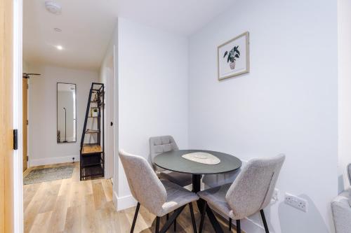 a dining room with a table and chairs and a ladder at Rock Mill - Superior Apartment with Private Patio in Stony Middleton
