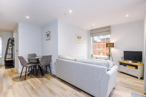 a living room with a couch and a table at Rock Mill - Superior Apartment with Private Patio in Stony Middleton