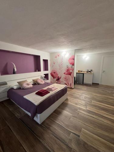 a bedroom with a large bed in a room at B&B Blue Dragonfly in Paesana