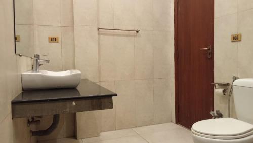a bathroom with a sink and a toilet at Royalz Hotel in Lahore