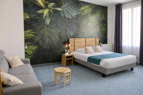 a bedroom with a bed and a couch at Cit' Hotel de France in Rochefort