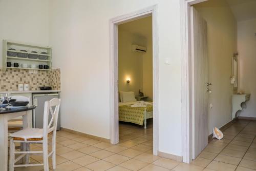 a kitchen with a table and a room with a bed at VILLA ROSA in Troulos