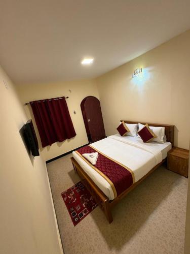 a bedroom with a large bed in a room at The Hill Bunk Heights Ooty in Ooty