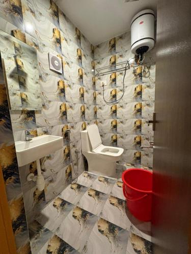 a bathroom with a toilet and a sink at The Hill Bunk Heights Ooty in Ooty