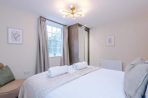 a bedroom with a white bed and a window at Rock Mill - Superior 2-Bedroom Apartment in Stony Middleton