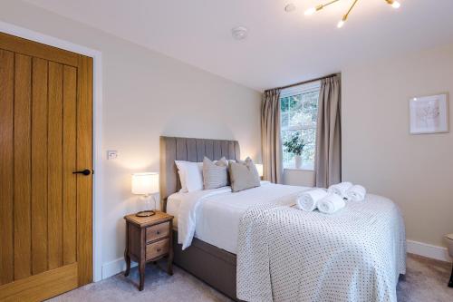 a bedroom with two beds and a window at Rock Mill - Superior 2-Bedroom Apartment in Stony Middleton
