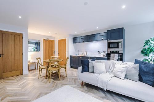 a living room with a couch and a kitchen at Rock Mill - Superior 2-Bedroom Apartment in Stony Middleton