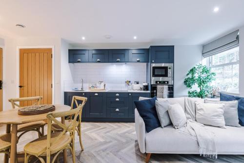 a living room with a couch and a table at Rock Mill - Superior 2-Bedroom Apartment in Stony Middleton