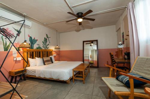 a bedroom with a bed and a ceiling fan at Selina Oaxaca in Oaxaca City