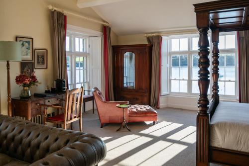 a bedroom with a bed and a desk and a chair at The Castle in Castlehaven