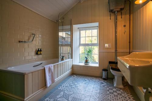 a bathroom with a tub and a sink and a toilet at The Castle in Castlehaven