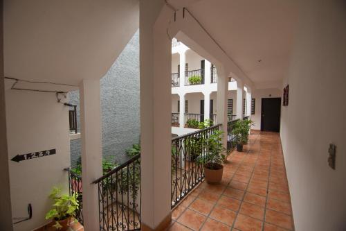 an empty hallway of a building with plants at Posada Kin in Palenque