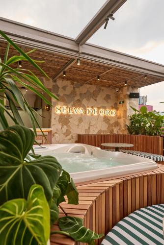 a hot tub in front of a building at Hotel Dix in Medellín