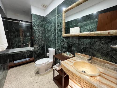 a bathroom with a sink and a toilet at Hotel Siglo 17 in Oaxaca City