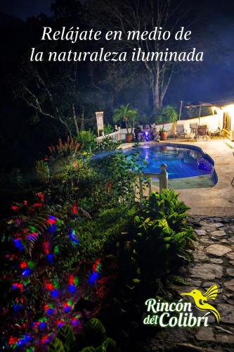 a picture of a swimming pool at night at Rincón del Colibrí in La Vega