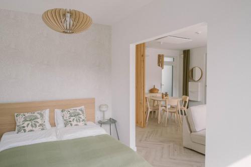 a bedroom with a bed and a dining room at Well M cottage in Velem
