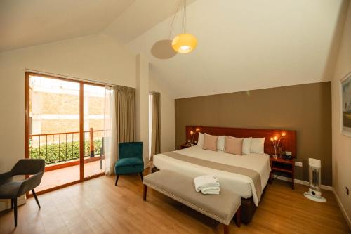 a hotel room with a bed and a balcony at Saska Boutique Hotel in Cusco