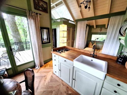 a kitchen with a sink and a counter top at Baumhaus auf dem Kellerberg in Fischach
