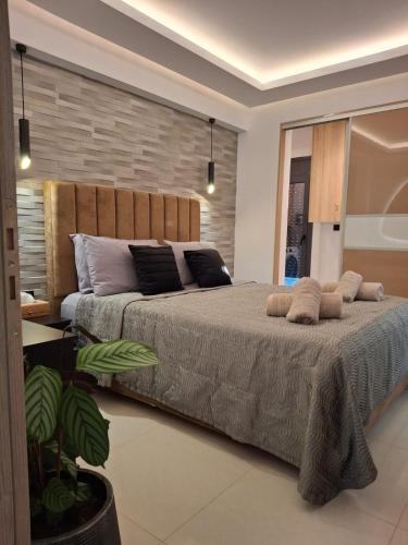 a bedroom with a large bed with two pillows at Prifti Luxury apartment in Faliraki