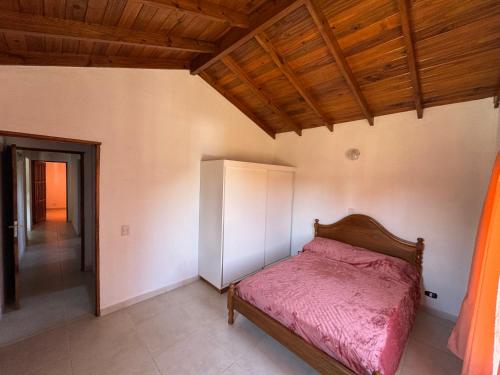 a bedroom with a bed and a wooden ceiling at Casa cairo in Ostende