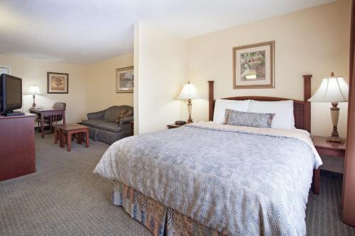 a hotel room with a bed and a television at Staybridge Suites Denver Tech Center by IHG in Centennial