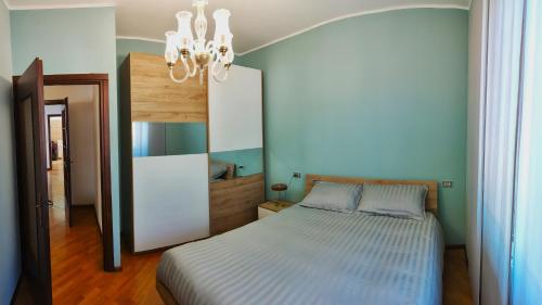 a bedroom with a bed and a chandelier at Ca Martin in Tresivio