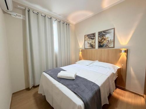 a bedroom with a large white bed in a room at Condomínio Reserva Almagre - MH in João Pessoa
