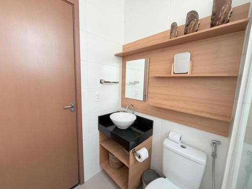 a small bathroom with a toilet and a sink at Condomínio Reserva Almagre - MH in João Pessoa