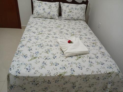 a bed with a pillow with a cherry on it at Quartos Festa do Peão Barretos in Barretos