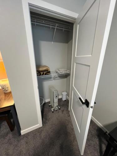 a room with a closet with a door open at Pond view Walkout in Airdrie