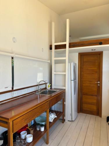 a kitchen with a sink and a refrigerator at Cabaña Sobre Playa Lago Gutiérrez 2 in San Carlos de Bariloche