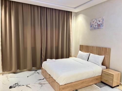 a bedroom with a bed and a large window at sahara house in Laayoune