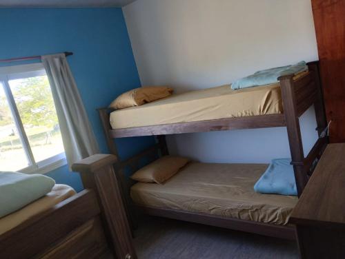 a small room with two bunk beds and a window at Cabaña gio in Potrero de Garay