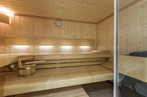 a sauna with wooden paneled walls and wooden floors at Sylter Inselglück in Wenningstedt