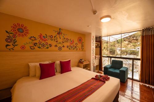 a bedroom with a bed and a chair and a window at Mayu Boutique Hotel in Cusco