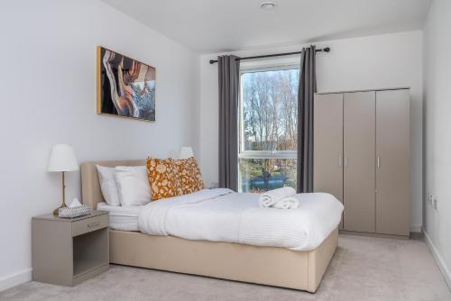 a bedroom with a large bed and a window at The Oasis in Stonewood