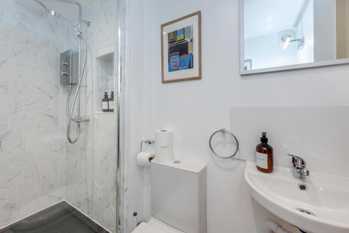 a white bathroom with a shower and a sink at 2 Bed in Shoreham-by-Sea oc-b29920 in Shoreham-by-Sea
