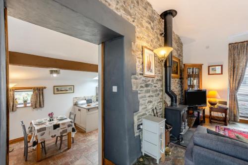 a living room with a table and a stone wall at 1 Bed in Windermere oc-f31665 in Crook