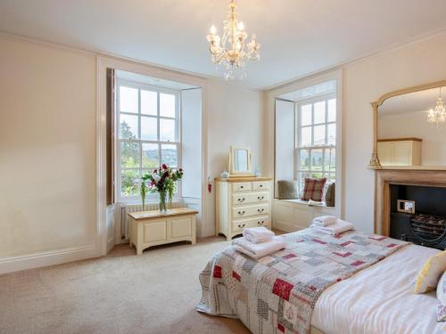 a bedroom with a large bed and a mirror at 3 Bed in Ambleside oc-62587 in Far Sawrey
