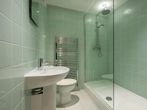 a bathroom with a sink and a toilet and a shower at 3 Bed in Ambleside oc-62587 in Far Sawrey