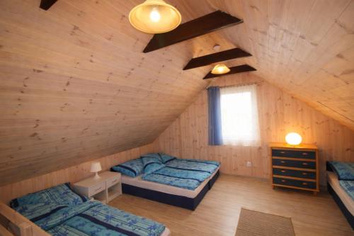 a bedroom with two beds in a attic at Morska Przygoda in Rewal